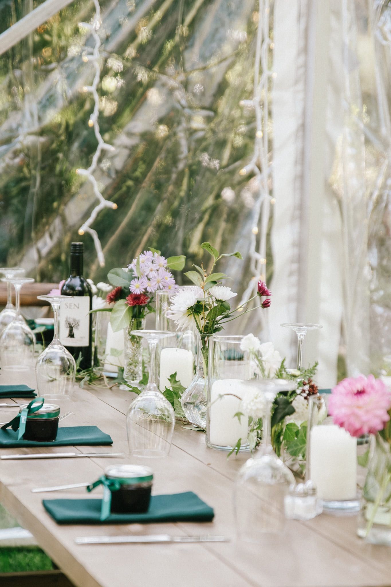 Simple wedding photos, reception table set with candles, glassware and pink flowers