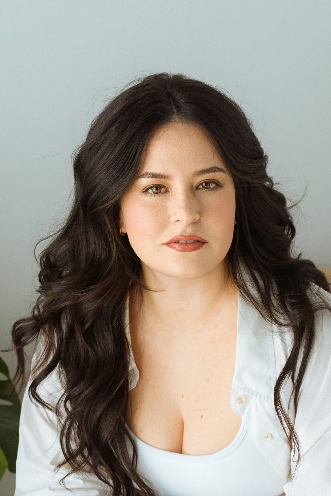 Indoor portrait photography in soft window light, woman with long dark hair in a white shirt, a portrait