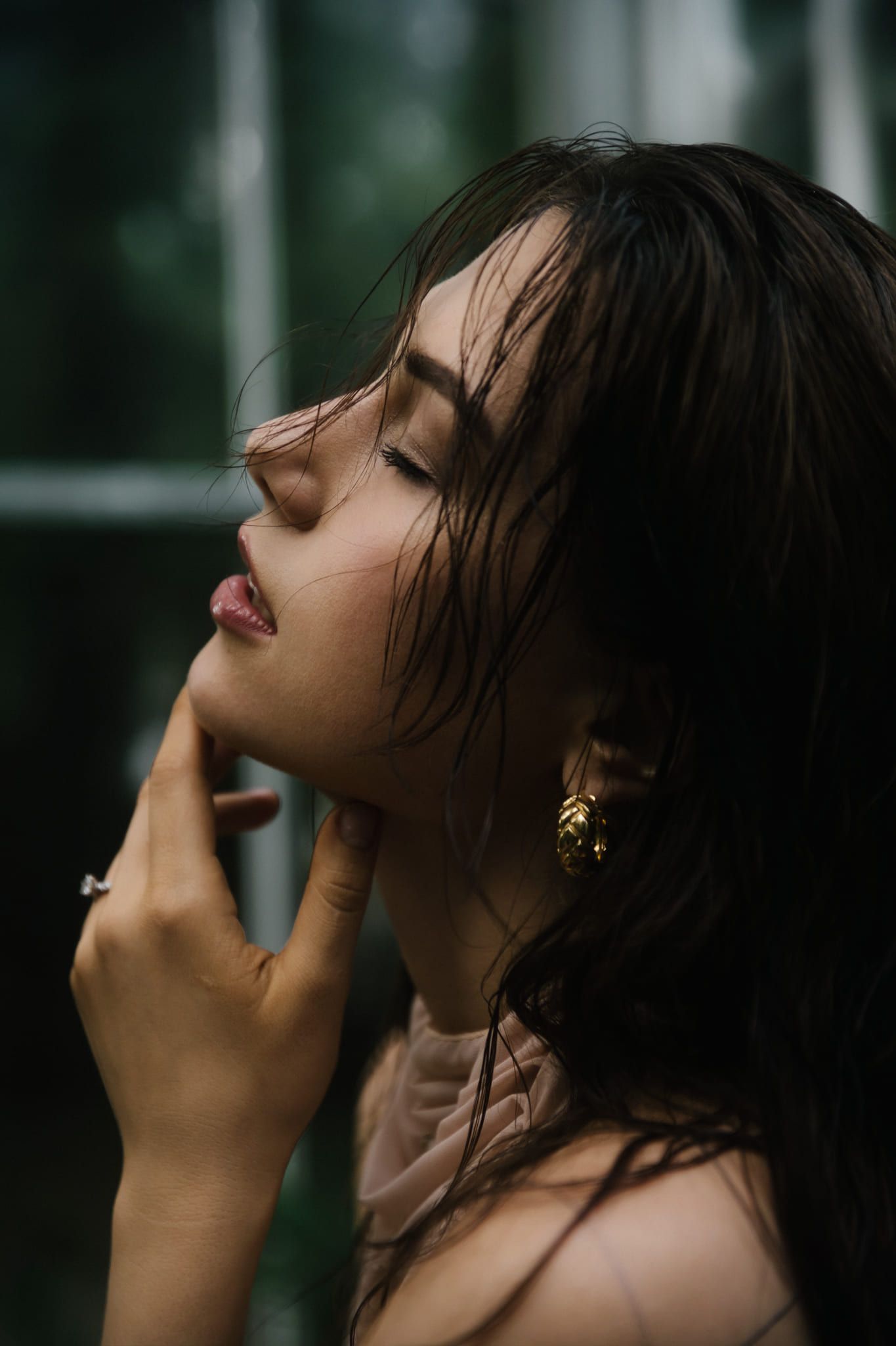 Portrait photo, close-up portrait of a woman with her eyes closed in soft window light
