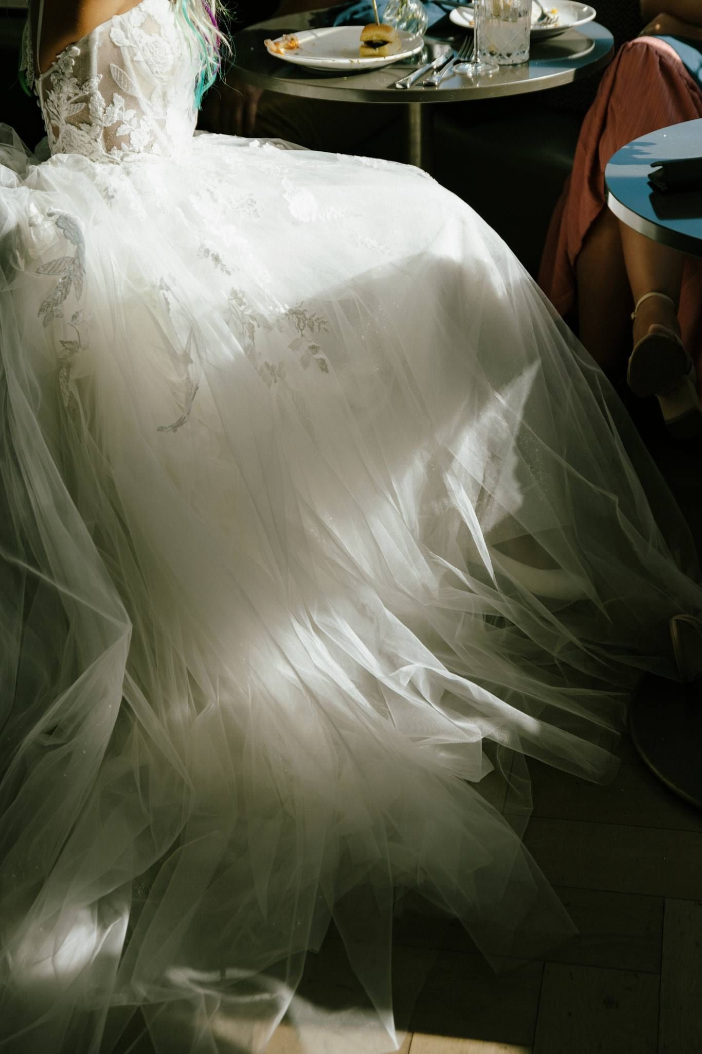 Bride's tulle skirt spread across the reception floor