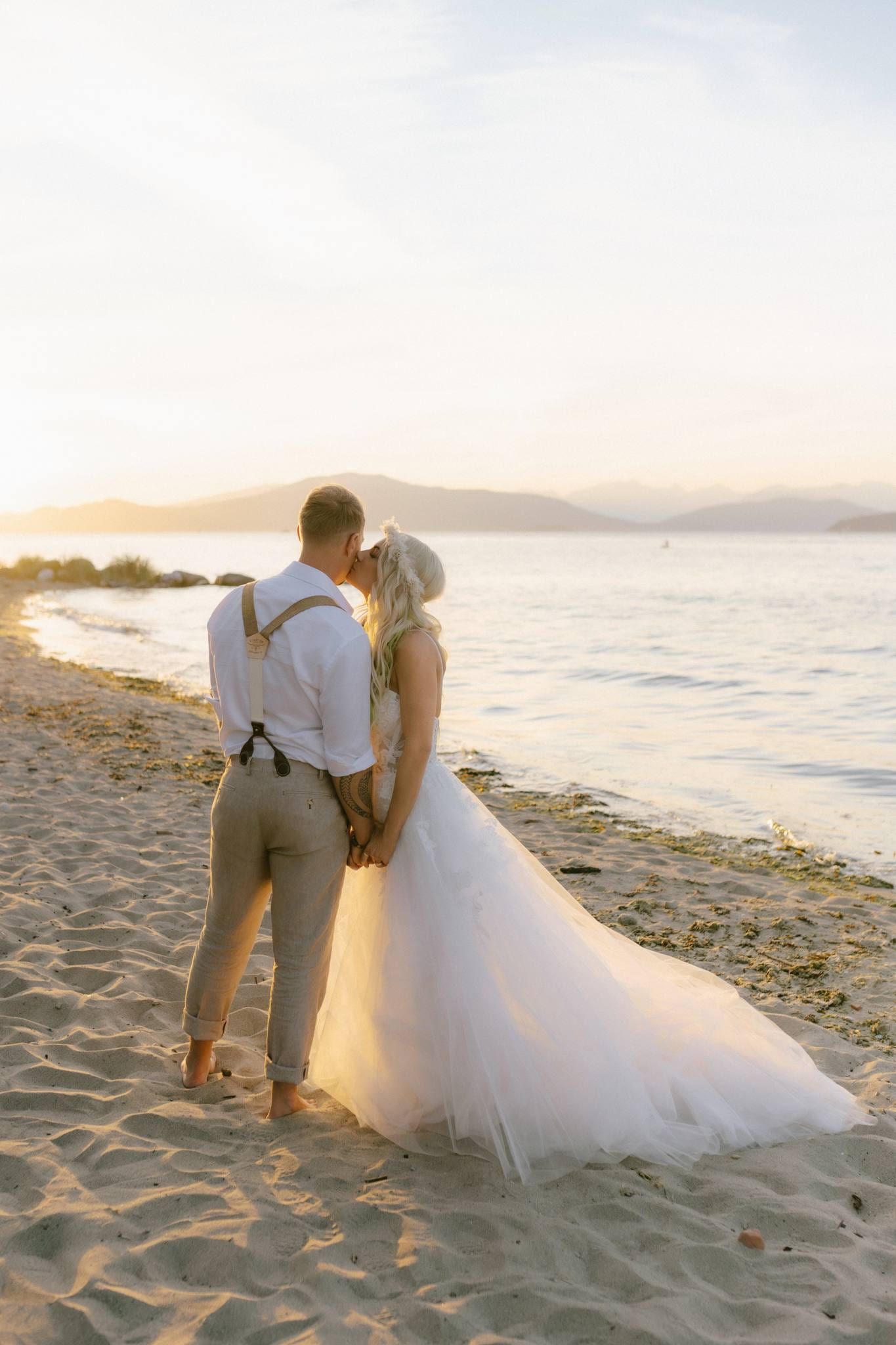 Couple holding hands on the beach at sunset