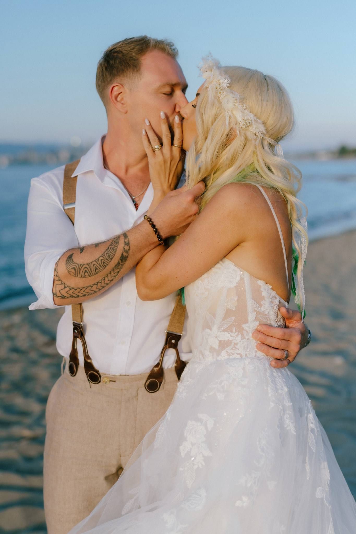 Groom kissing the bride by the water