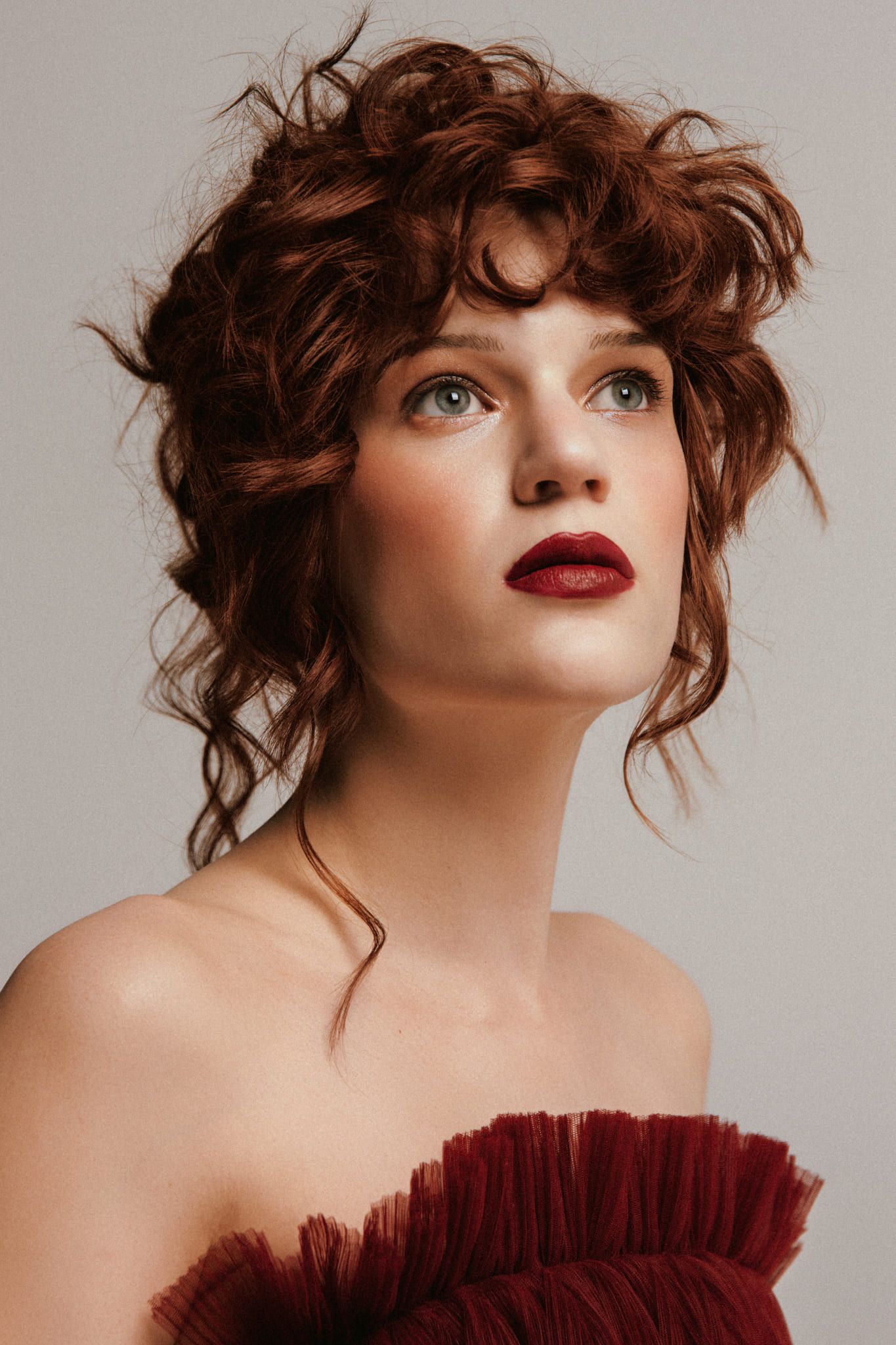 Branding photography, portrait of a woman with red curls and a ruffled red top